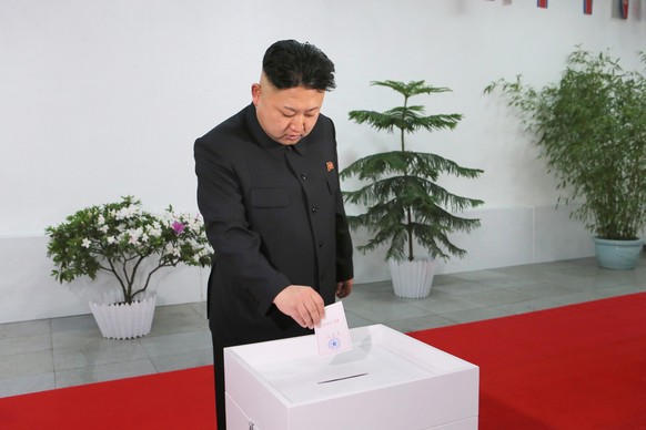 epaselect epa04118080 A picture released by the North Korea Central News Agency (KCNA) on 10 March 2014 shows North Korean leader Kim Jong-un casting a ballot at a polling station at the Kim Il-sung University of Politics in Pyongyang, North Korea, 09 March 2014, to elect the Supreme People's Assembly. It is the first election for the North's rubber-stamp parliament since Kim took over power in December 2011 after the death of his father Kim Jong-il. The election is held every five years.  EPA/KCNA SOUTH KOREA OUT