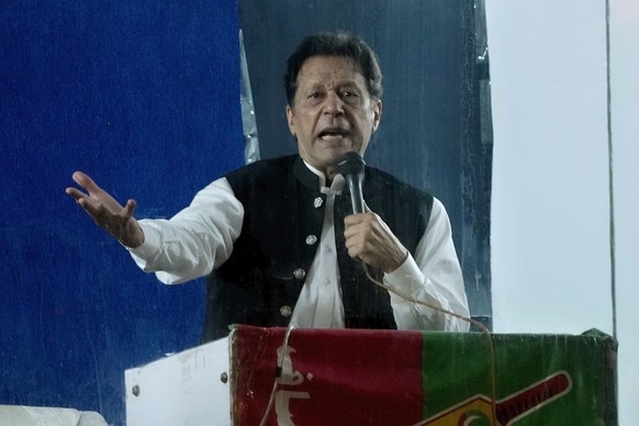 Protected by a bulletproof barrier, former Prime Minister Imran Khan speaks at a rally in Lahore, Pakistan, Sunday, March 26, 2023, to pressure Shahbaz Sharif's government to agree to hold sn...