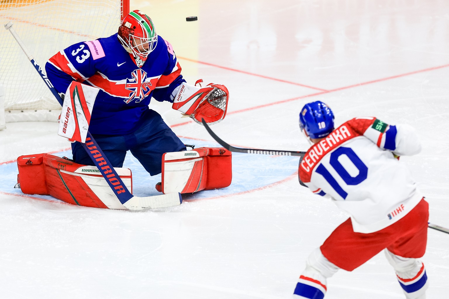 epa11351507 Roman Cervenka of Czech Republic (R) in action against goalkeeper Ben Bowns of Great Britain (L) during the preliminary round group A match between Czech Republic and Great Britain at the  ...