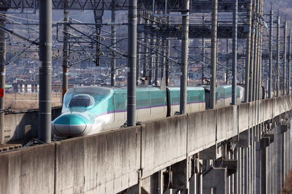 epa09830092 The Tohoku shinkansen bullet train remains on the track after it derailed due to a strong earthquake in Shiroishi, Miyagi prefecture, northeastern Japan, 17 March 2022. A 6.4 magnitude ear ...