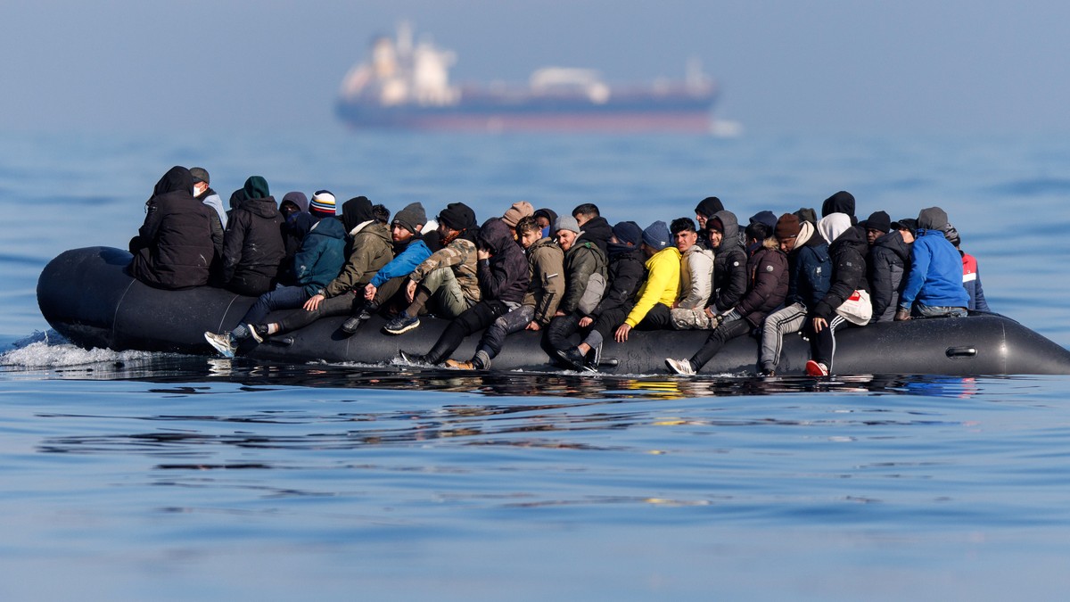 epa11202050 Around 60 migrants cross the English Channel on a small boat, on 06 March 2024. The UK government has suffered more setbacks at the House of Lords recently on its plan to send migrants to  ...