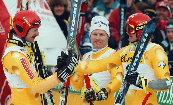 Swiss ski racers Paul Accola, right, Urs Kaelin, center and Michael von Gruenigen, left, congratulate each other in the arrival area of the ski worldcup giant slalom at Adelboden, Tuesday, January 13t ...