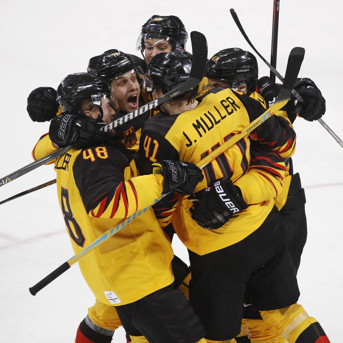 Jonas Muller (41), of Germany, celebrates with teammates after scoring a goal during the third period of the men's gold medal hockey game against the Olympic athletes from Russia at the 2018 Wint ...