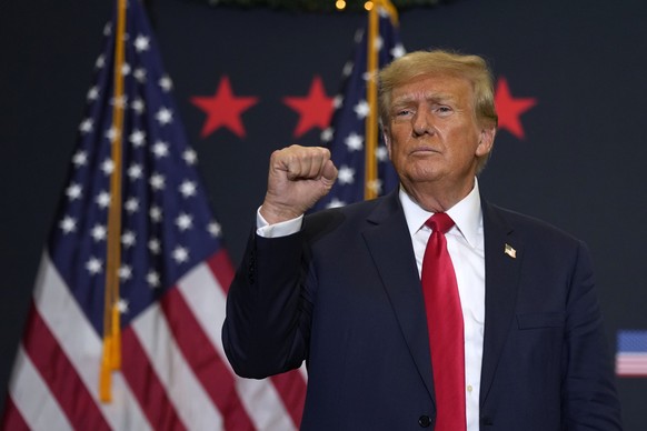 Former President Donald Trump reacts to supporters during a commit to caucus rally, Tuesday, Dec. 19, 2023, in Waterloo, Iowa. (AP Photo/Charlie Neibergall)