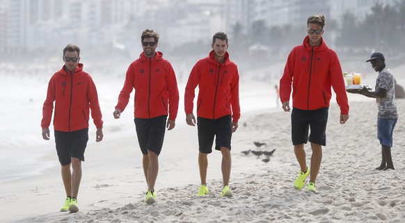 Swiss rowing athletes of the lightweigt four team, Simon Niepmann, Mario Gyr, Lucas Tramer and Simon Schuerch, from left, pose on Ipanema beach during a media conference of the Swiss Rowing Team prior ...