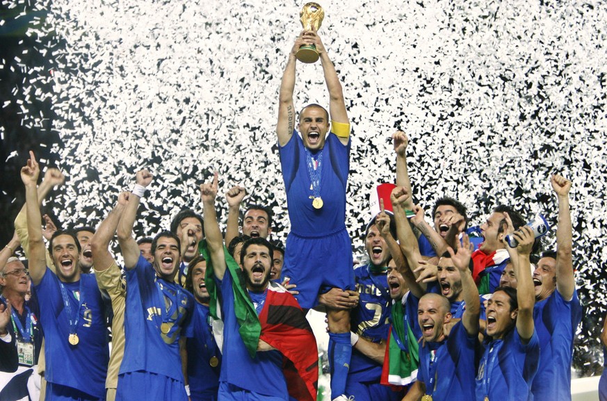Italy's Fabio Cannavaro lifts the trophy after defeating France 5-3 in a shootout in the final of the soccer World Cup between Italy and France in the Olympic Stadium in Berlin, Sunday, July 9, 2 ...