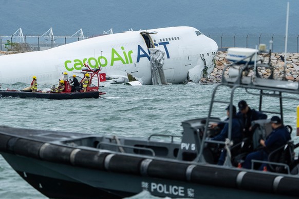 Rescue workers approach a cargo aircraft that skidded off a Hong Kong runway on Monday, Oct. 20, 2025. (AP Photo/Chan Long Hei)
Hong Kong Plane