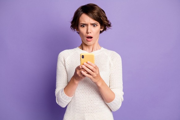 shocked woman on mobile phone