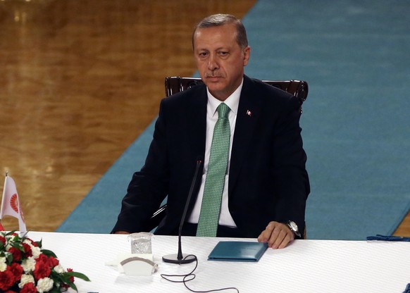 Turkey&#039;s President Recep Tayyip Erdogan waits to address a group of lawmakers from the ruling party at the parliament in Ankara, Turkey, Friday, July 22, 2016. Parliament voted 346-115 to approve ...