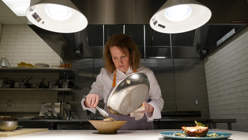 Amy Brandwein, chef and owner of Centrolina, prepares a dish in her restaurant kitchen, Thursday, Dec. 16, 2021, in Washington. While restaurants in the U.S. and United Kingdom are open without restri ...