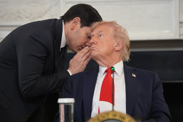 Secretary of State Marco Rubio whispers to President Donald Trump, who is holding the note Rubio handed to him, during a roundtable meeting on antifa in the State Dining Room at the White House, Wedne ...