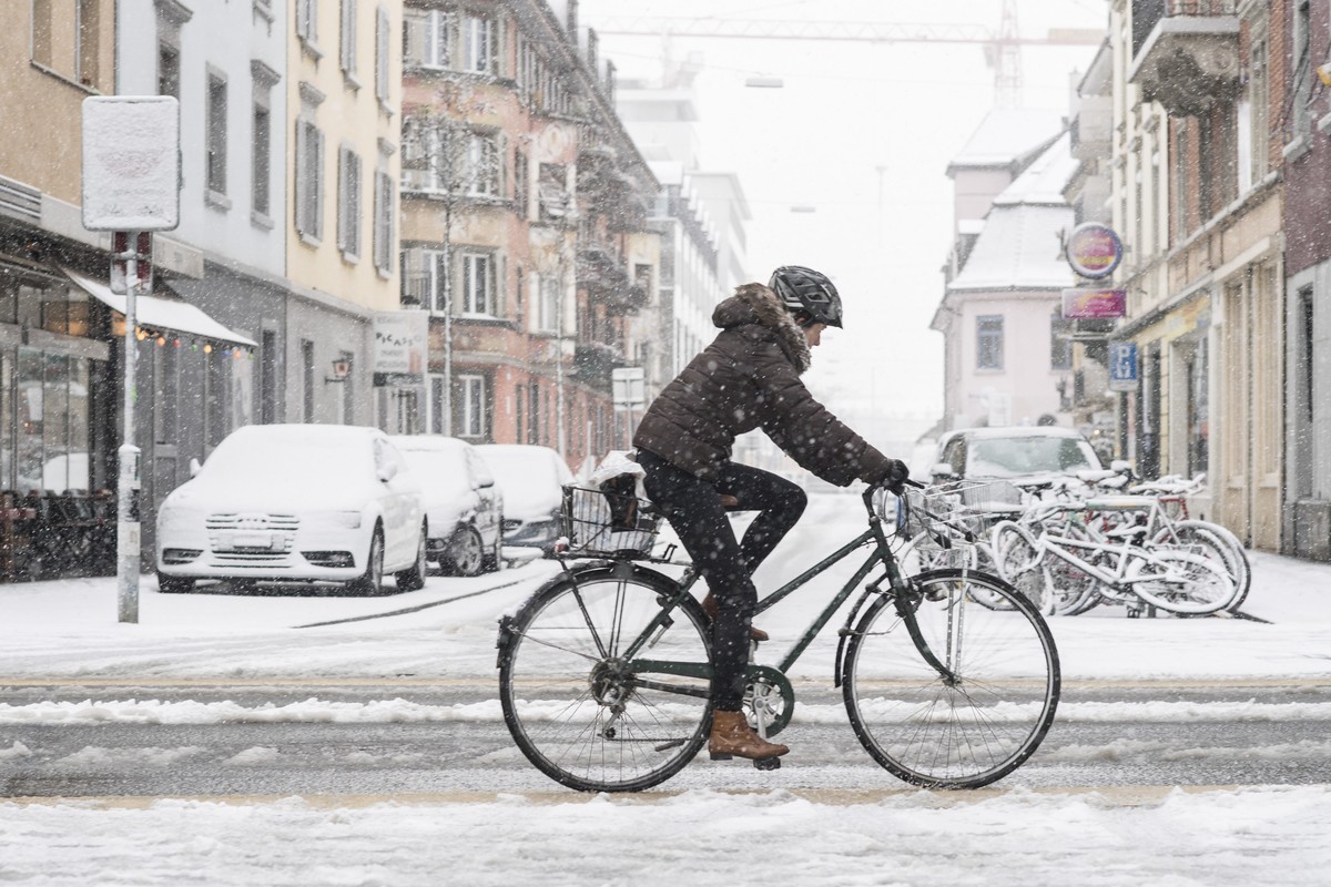 Eine Frau faehrt auf ihhrem Rad durch die verschneiten Strassen in Zuerich, aufgenommen am Mittwoch, 17. Januar 2018. (KEYSTONE/Ennio Leanza)