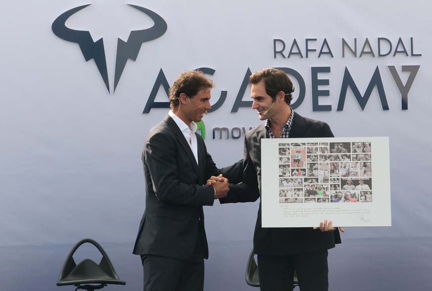 Switzerland&#039;s Roger Federer holds a gift given by Spain&#039;s Rafael Nadal during the opening ceremony of the Rafa Nadal tennis academy in Manacor, Spain, October 19, 2016. REUTERS/Enrique Calvo