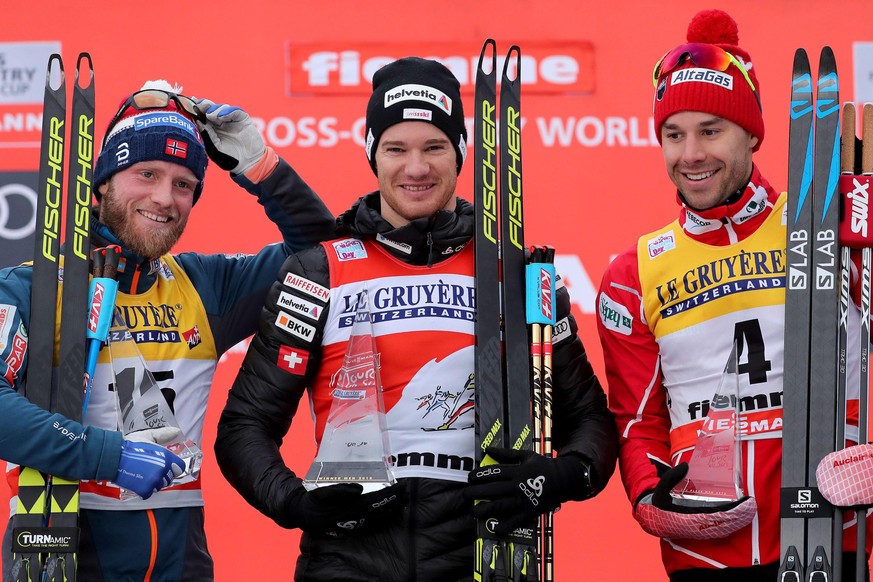 epa06422935 Winner Dario Cologna (C) of Switzerland with second placed Martin Johnsrud Sundby (L) of Norway and third placed Alex Harvey (R) of Canada celebrate on the podium after the men&#039;s 9 km ...