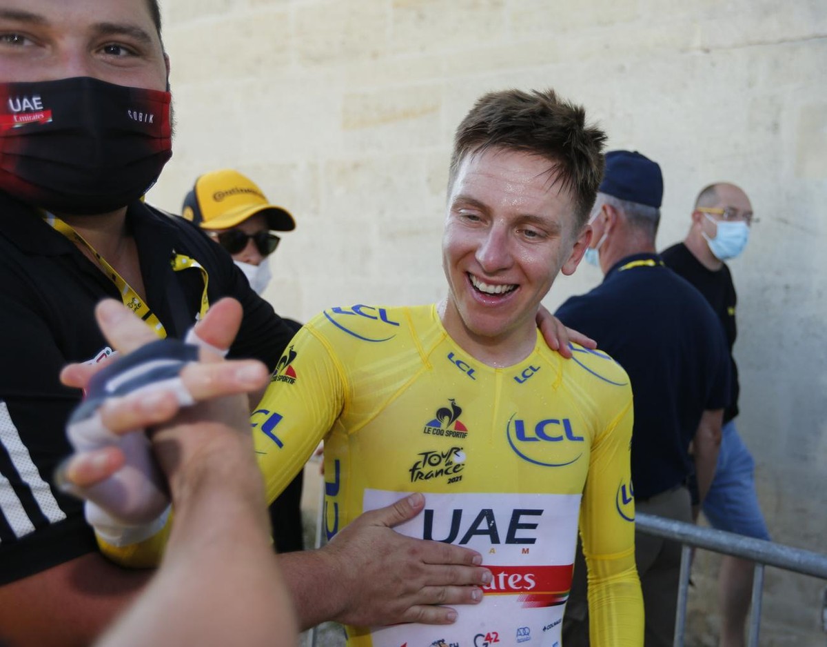 Slovenia's Tadej Pogacar, wearing the overall leader's yellow jersey, celebrates after the twentieth stage of the Tour de France cycling race, an individual time-trial over 30.8 kilometers ( ...