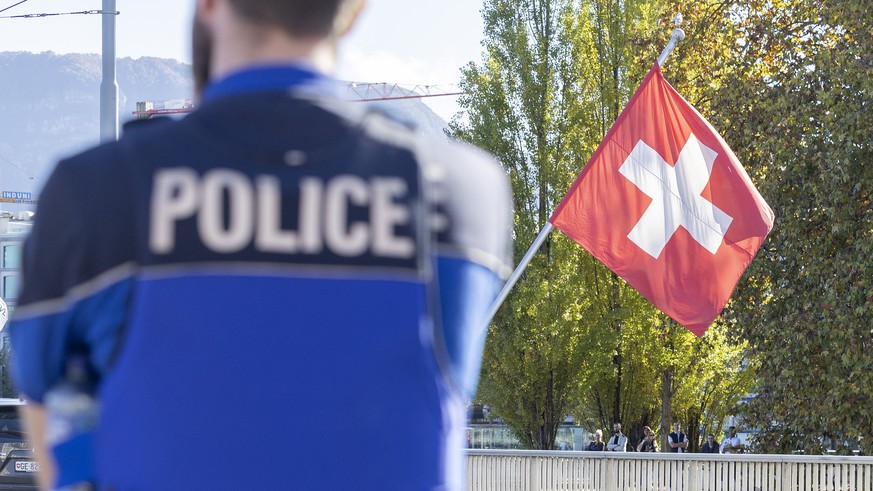 Swiss police officers controls the area where a climate activist from Renovate Switzerland have glued his hand to the ground during the &quot;Renovate Switzerland&quot; roadblock action at the pont du ...