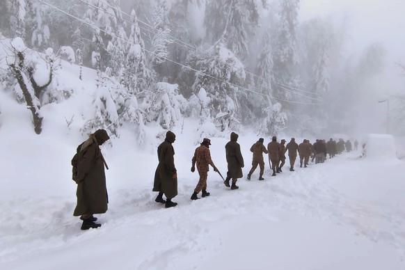 In this photo provided by the Inter Services Public Relations, army members take part in a rescue operation in a heavy snowfall-hit area in Murree, some 28 miles (45 kilometers) north of the capital o ...