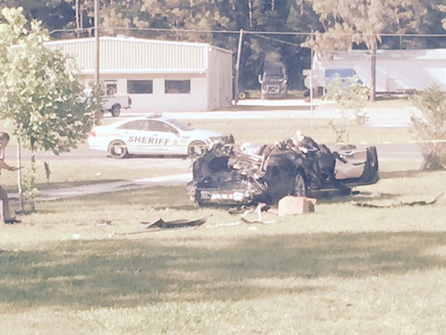 A Tesla Model S involved in the fatal crash on May 7, 2016 is shown with the top third of the car sheared off by the impact of the collision of the Tesla with a tractor-trailer truck on nearby highway ...