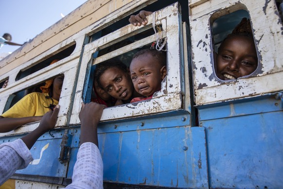 Tigray refugees who fled the conflict in the Ethiopia&#039;s Tigray ride a bus going to the Village 8 temporary shelter, near the Sudan-Ethiopia border, in Hamdayet, eastern Sudan, Tuesday, Dec. 1, 20 ...
