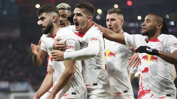 RB Leipzig players celebrate after Leipzig&#039;s Josko Gvardiol, left, scored his side&#039;s opening goal during the UEFA Champions League round of sixteen first leg soccer match between RB Leipzig  ...