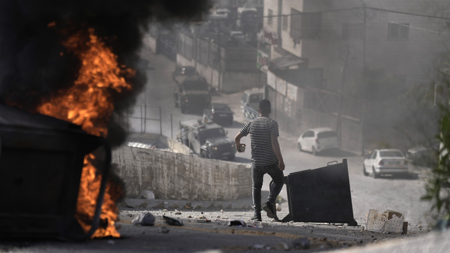 A Palestinian clashes with Israeli forces in the West Bank town of Nablus, during a military operation, Tuesday, May 9, 2023. (AP Photo/Majdi Mohammed)