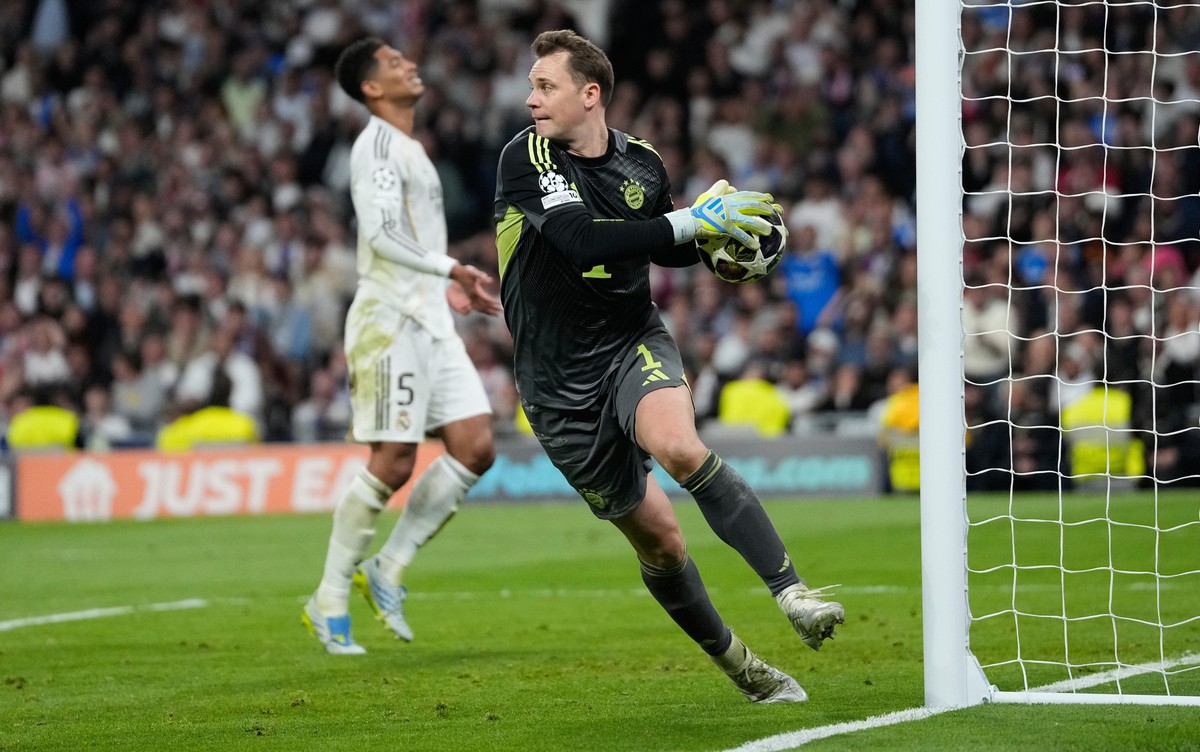 Bayern's goalkeeper Manuel Neuer saves the ball during the Champions League quarterfinal first leg soccer match between Real Madrid and Bayern Munich in Madrid, Spain, Tuesday, April 7, 2026. (AP ...