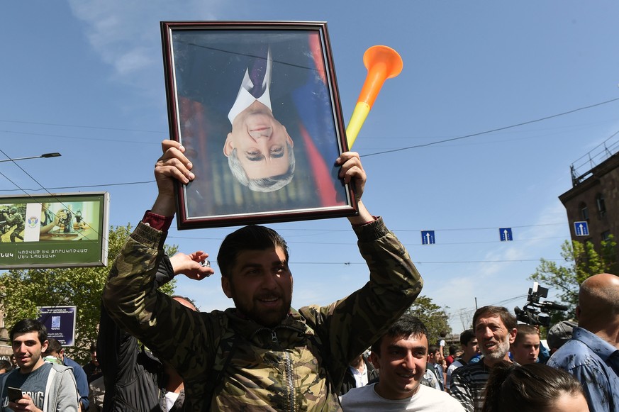 epa06679133 Activists of '#merjirserjin' (Reject Serzh) initiative hold a protest march against recently nominated Armenian Prime Minsiter, former President Serzh Sargsyan in Yerevan, Armeni ...