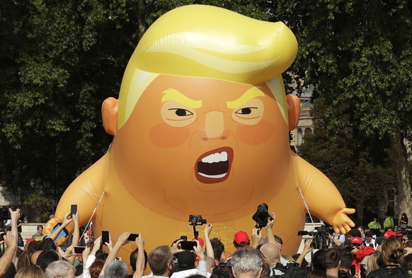 FILE - In this Friday, July 13, 2018 file photo, a six-meter high cartoon baby blimp of U.S. President Donald Trump is flown as a protest against his visit, in Parliament Square in London, England. Tr ...