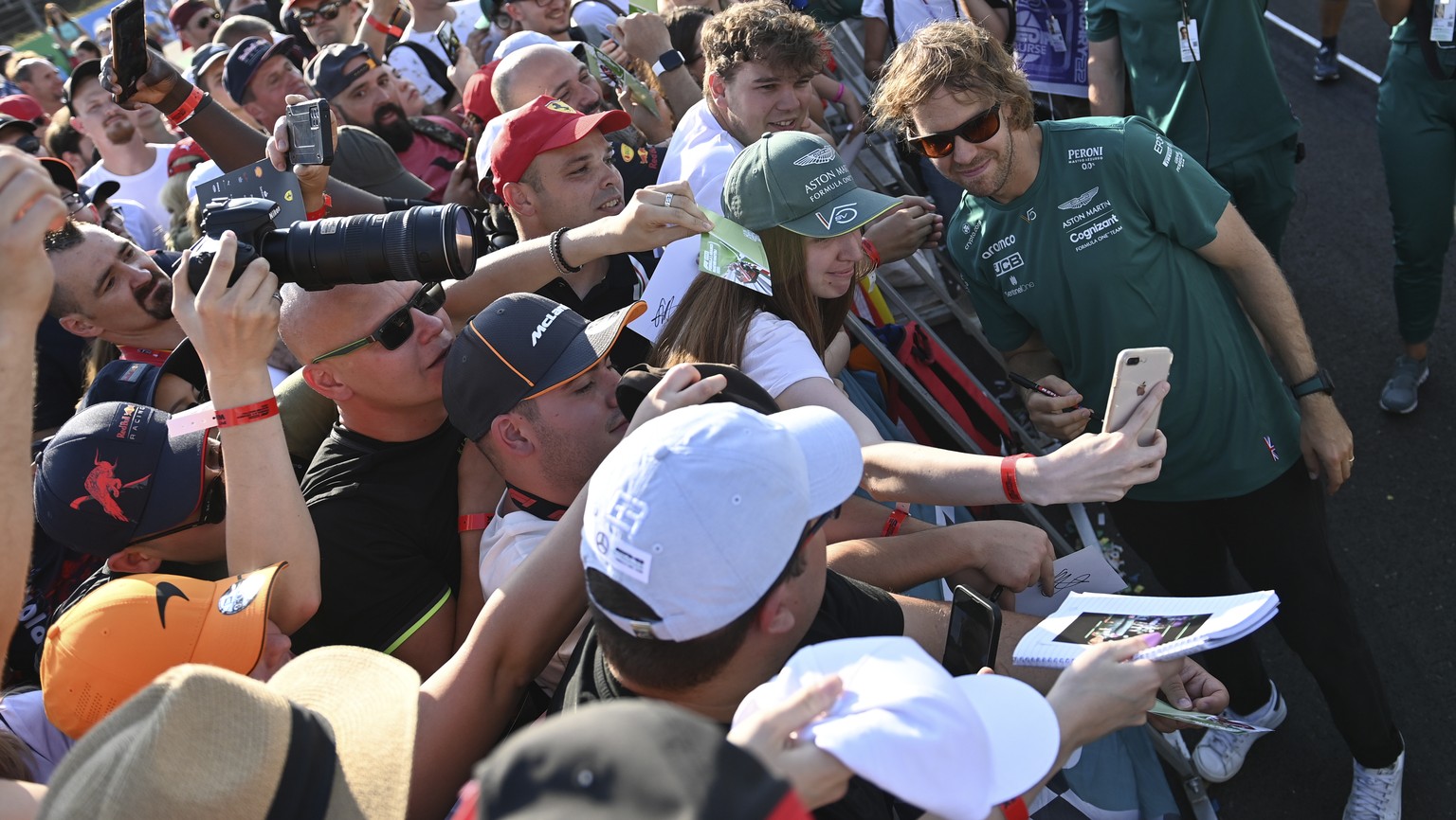 Aston Martin driver Sebastian Vettel of Germany greets supporters at the Hungaroring racetrack in Mogyorod, near Budapest, Hungary, Thursday, July 28, 2022. The Hungarian Formula One Grand Prix will b ...