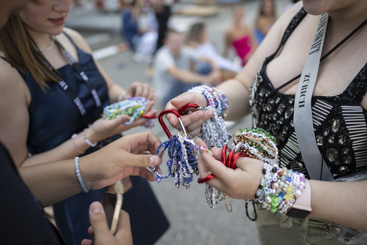 Fans, also known as 'Swifties', wait to attend the concert of US singer and songwriter Taylor Swift as part of her 'The Eras Tour' in front of the Letzigrund Stadium in Zurich, Swi ...