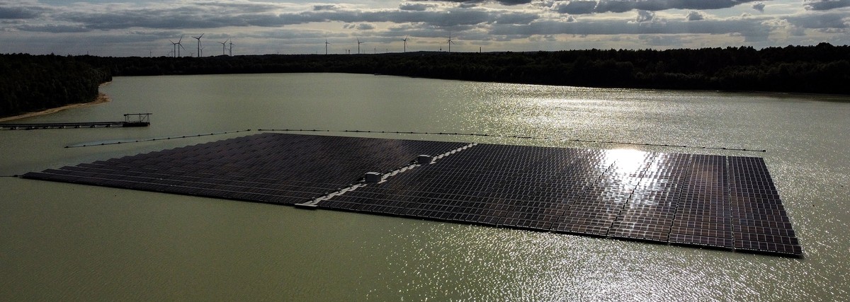 epa10094448 An aerial photo taken with a drone shows solar panels on Germany's biggest floating photovoltaic plant on lake Silbersee in Haltern, Germany, 27 July 2022. More than 5,000 photovoltai ...