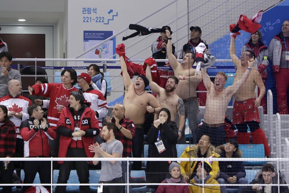 Canada fans react after a goal by Wojtek Wolski during the second period of a preliminary round men&#039;s hockey game against Switzerland at the 2018 Winter Olympics in Gangneung, South Korea, Thursd ...