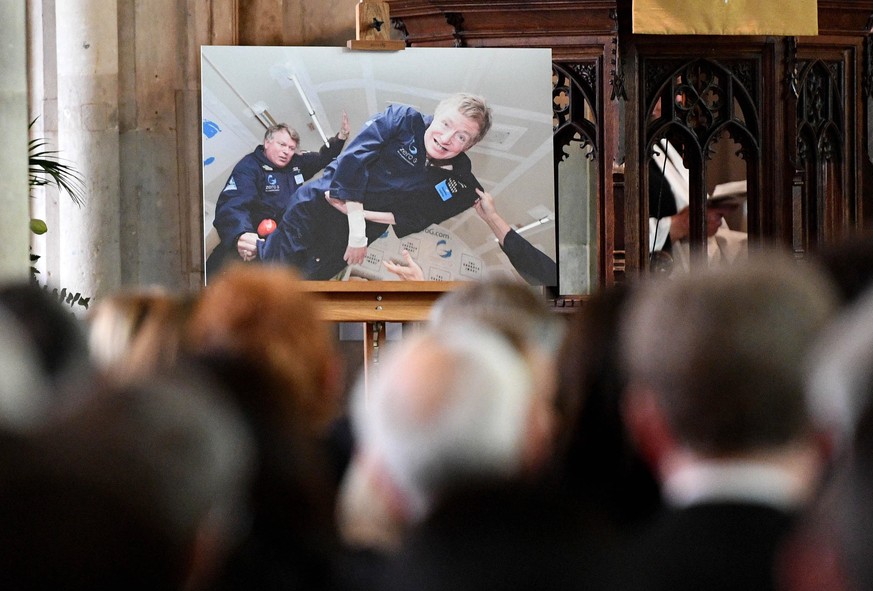 epa06639139 A picture of Stepehn Hawking in zero gravity is displayed during the funeral of Stephen Hawking at the University Church of St. Mary the Great in Cambridge, Britain, 31 March 2018. World-r ...