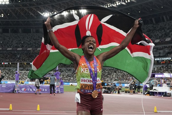 Kenya's Faith Kipyegon celebrates after winning gold medal in the women's 1500 meters final at the World Athletics Championships in Tokyo, Tuesday, Sept. 16, 2025. (AP Photo/Eugene Hoshiko)
 ...