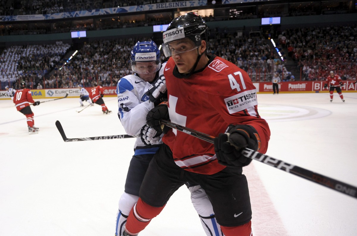 Finland's Petri Kontiola, rear, tackles Luca Sbisa of Switzerland during their Group H game Finland vs Switzerland of the 2012 IIHF Ice Hockey World Championships in Helsinki, Finland Tuesday, Ma ...