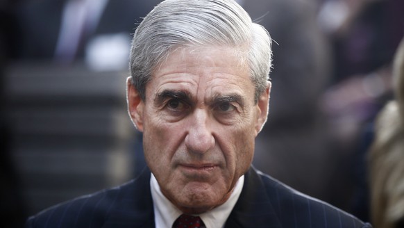 FILE - In this Oct. 28, 2013, file photo, former FBI Director Robert Mueller is seated before President Barack Obama and FBI Director James Comey arrive at an installation ceremony at FBI Headquarters ...