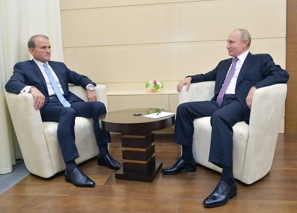 Ukrainian tycoon Viktor Medvedchuk, left, speaks to Russian President Vladimir Putin during a meeting at the Novo-Ogaryovo residence outside Moscow, Russia, Tuesday, Oct. 6, 2020. Medvedchuk, who head ...