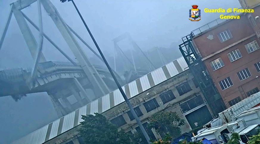 epa07686756 A handout video grab taken from a CCTV video made available by the Italian Guardia di Finanza (GdF) on 01 July 2019 shows the moment the Morandi Bridge collapsed on 14 August 2018 in Geboa ...