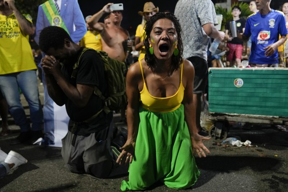 Supporters of Brazilian President Jair Bolsonaro react to results after polls closed in a presidential run-off election, in Rio de Janeiro, Brazil, Sunday, Oct. 30, 2022. Brazil&#039;s electoral autho ...