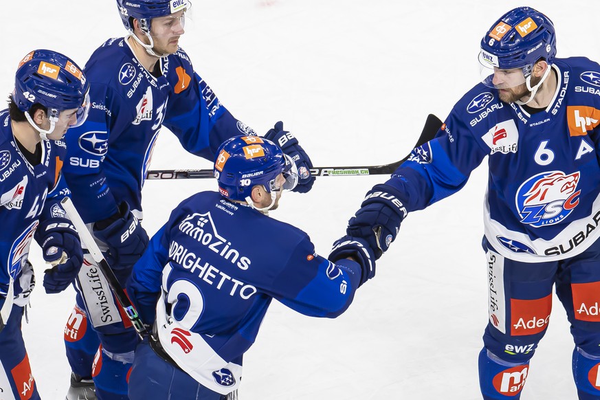 Zurich's Sven Andrighetto, center, cheers with his teammates after his goal that made it 3-1 in a National League ice hockey match between ZSC Lions and EHC Kloten, on Friday, December 9, 2022 in...