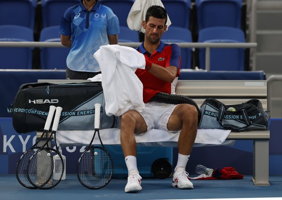 epa09379180 Novak Djokovic of Serbia rests during a break at the Men&#039;s Singles Semifinal Tennis events of the Tokyo 2020 Olympic Games at the Ariake Coliseum in? Tokyo, Japan, 30 July 2021. EPA/R ...