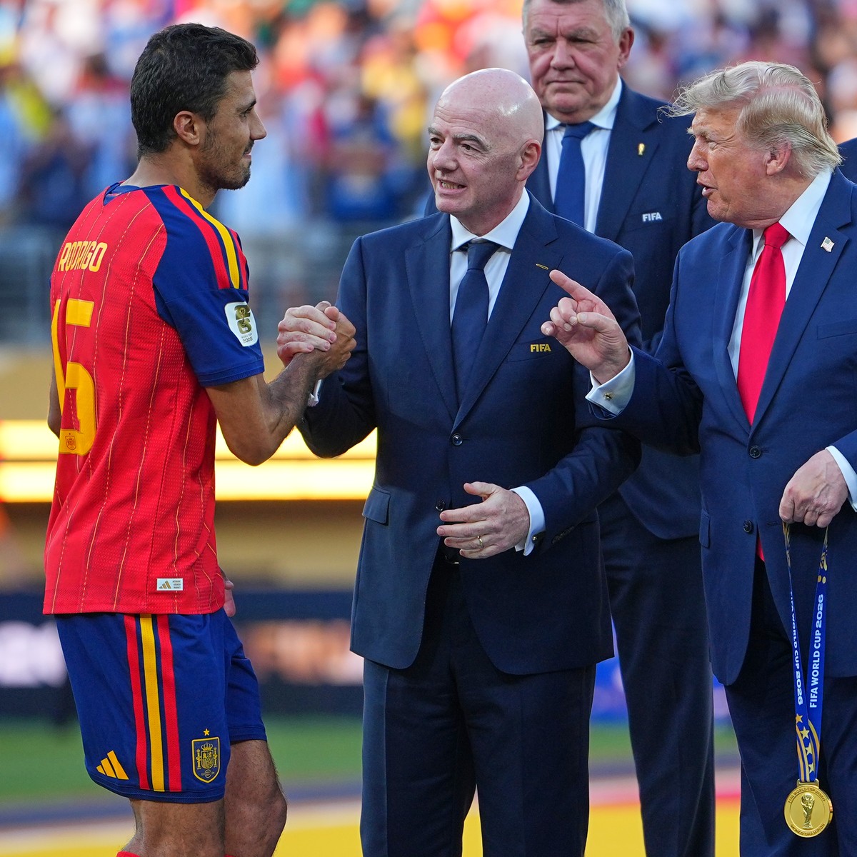 Spain's Rodri (16) is greeted by FIFA President Gianni Infantino and President Donald J. Trump during the presentation ceremony after the World Cup final soccer match between Spain and Argentina  ...