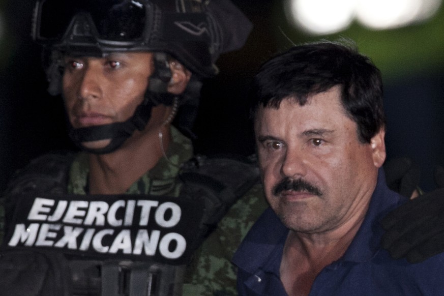 FILE - In this Jan. 8, 2016, file photo, Mexican drug lord Joaquin &quot;El Chapo&quot; Guzman, right, is escorted by soldiers and marines to a waiting helicopter, at a federal hangar in Mexico City,  ...