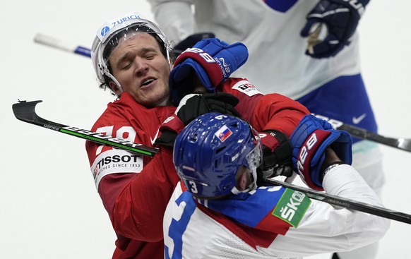 Calvin Thurkauf of Switzerland, left, fights with Slovakia&#039;s Adam Janosik after the group A Hockey World Championship match between Switzerland and Slovakia in Helsinki, Finland, Wednesday May 18 ...