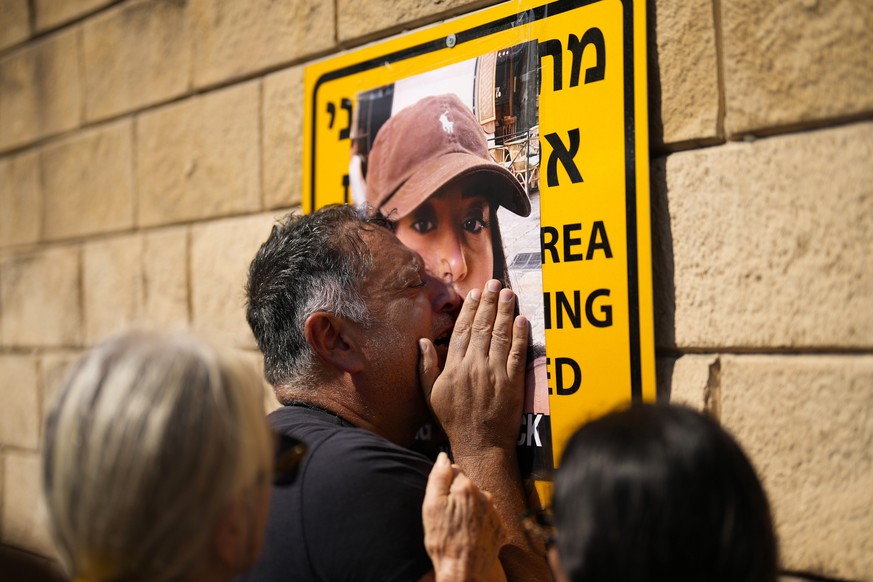 FILE - Eli Albag cries over the photograph of his daughter Liri, as he gathers with others during a protest demanding the release of dozens of Israelis who were abducted during last week&#039;s unprec ...