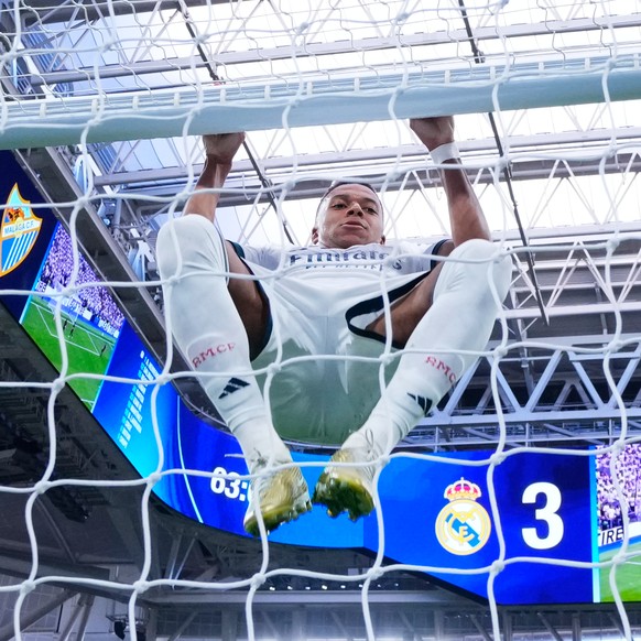 Real Madrid's Kylian Mbappe hangs on the goal post during the La Liga soccer match between Real Madrid and Malaga in Madrid, Spain, Sunday, Aug. 30, 2026. (AP Photo/Manu Fernandez)
Kylian Mbappe