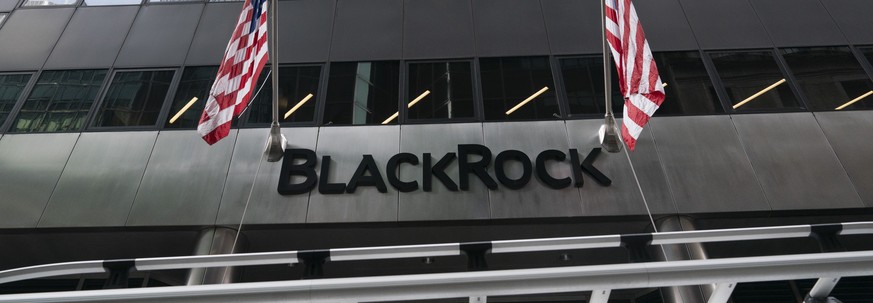 Flags fly on the front of BlackRock headquarters, Wednesday, Jan. 13, 2021, in New York. The financial asset manager reports earnings Thursday, Jan. 14. (AP Photo/Mark Lennihan)