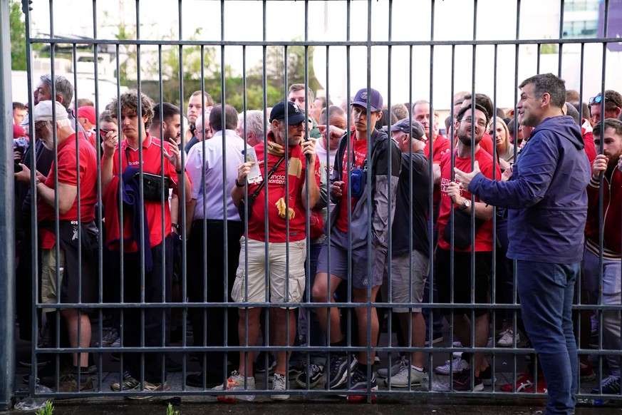 Liverpool fans file photo File photo dated 28-05-2022 of of Liverpool fans stuck outside the ground show their match tickets off at the Stade de France, Paris. Liverpool fans were unfairly blamed for  ...