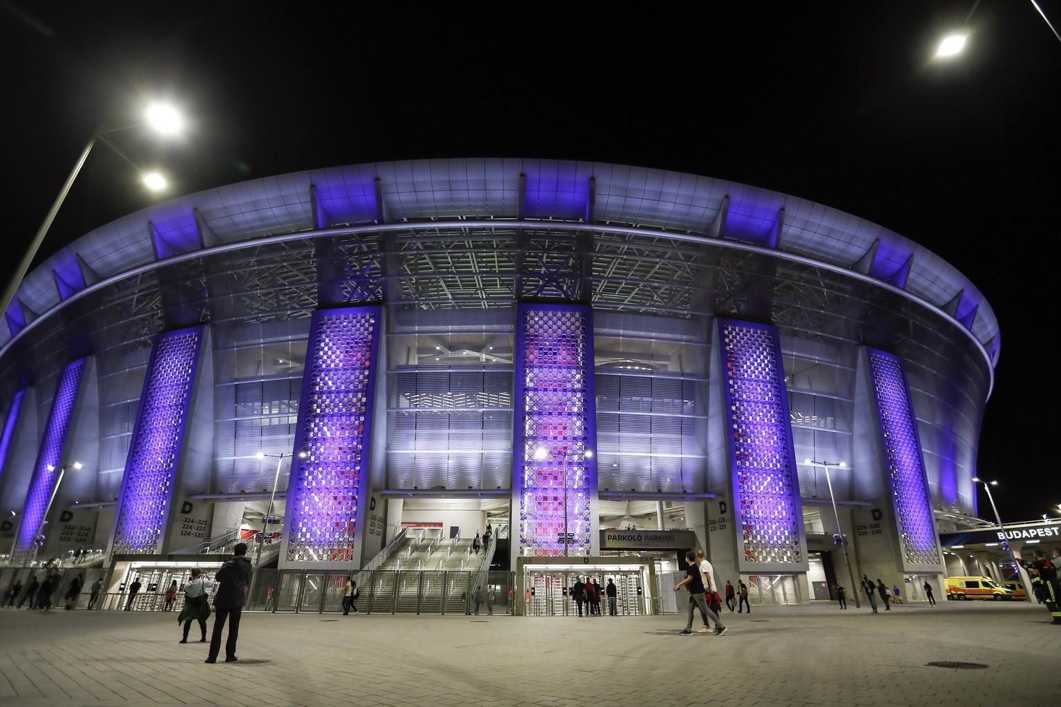 FILE - In this file photo dated Thursday, Sept. 24, 2020, a few people walk outside the stadium before the UEFA Super Cup soccer match between Bayern Munich and Sevilla at the Puskas Arena in Budapest ...