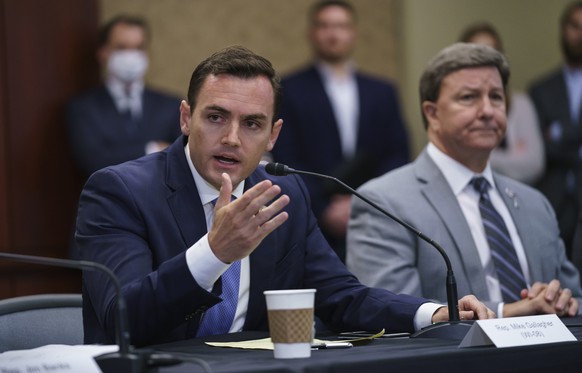 Rep. Mike Gallagher, R-Wis., left, a former Marine, joined at right by Rep. Mike Rogers, R-Ala., ranking member of the House Armed Services Committee, speaks during a roundtable discussion with House  ...